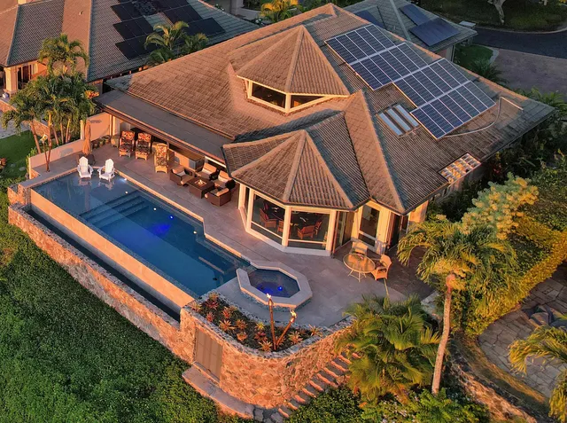 an aerial view of a house with a yard