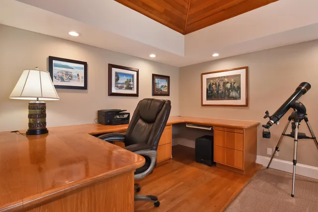 a workspace with wooden floor and furniture