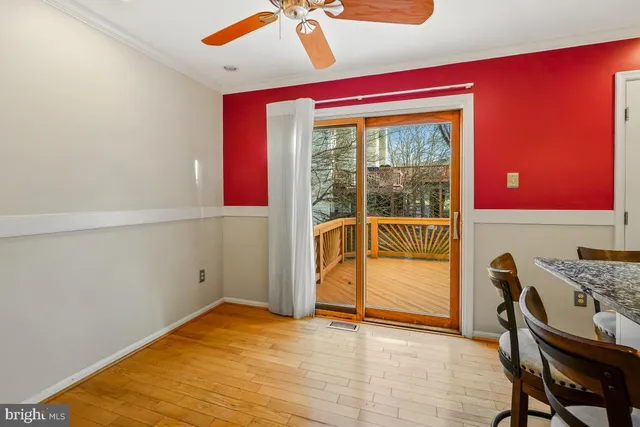 a kitchen with stainless steel appliances kitchen island granite countertop a table chairs and a refrigerator