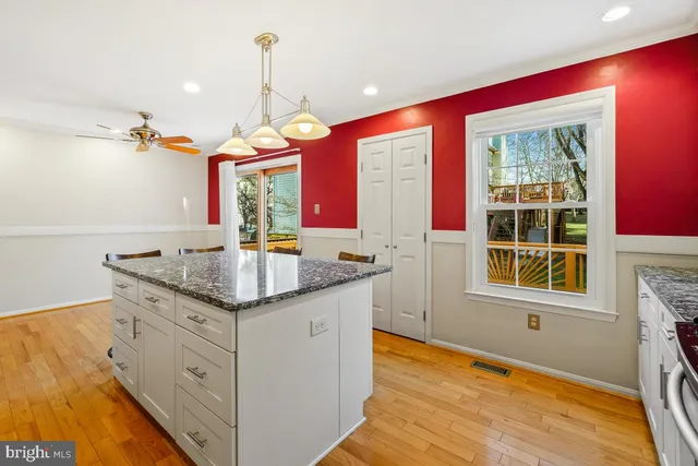 a kitchen with stainless steel appliances granite countertop a sink a stove and a microwave
