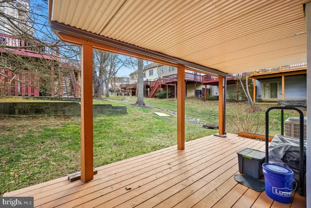 a view of a deck with wooden floor and iron stairs