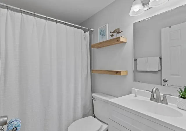 a bedroom with two beds and a window