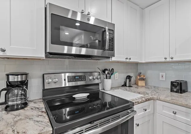 a kitchen with refrigerator and cabinets