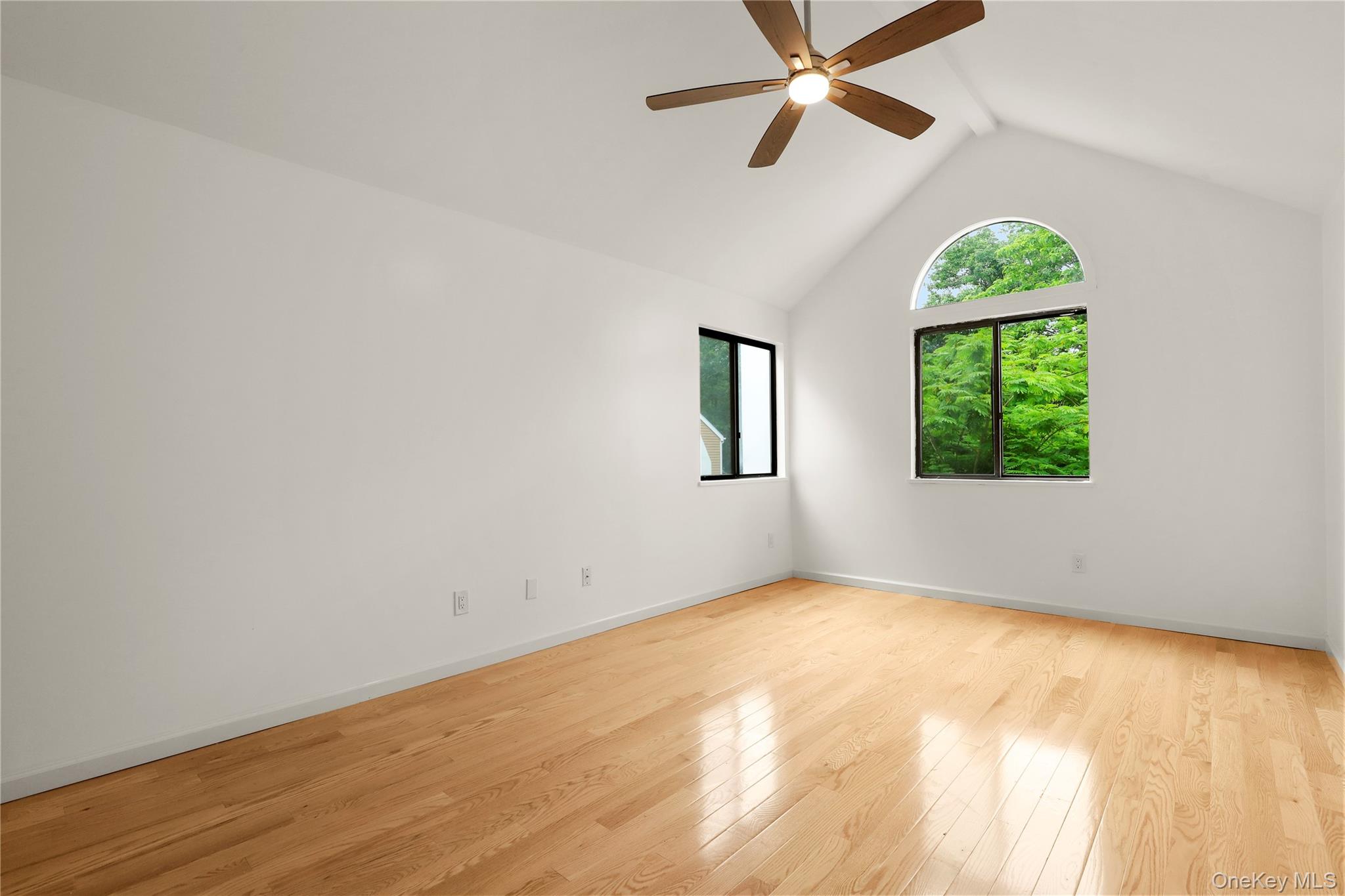 41 Rambling Brook Road Chappaqua, NY 10514 - Photo 16 of 29 Spare room with a ceiling fan, lofted ceiling, light wood-style flooring, and baseboards