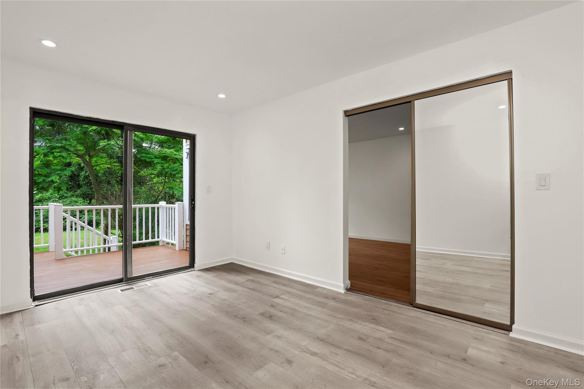 41 Rambling Brook Road Chappaqua, NY 10514 - Photo 25 of 29 Unfurnished bedroom featuring access to exterior, light wood-style floors, baseboards, recessed lighting, and a closet