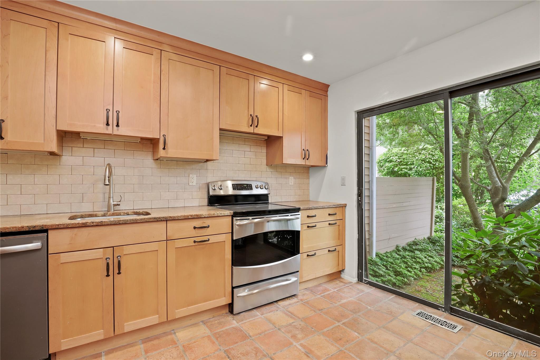 41 Rambling Brook Road Chappaqua, NY 10514 - Photo 6 of 29 Kitchen with stainless steel appliances, a sink, light brown cabinets, tasteful backsplash, and recessed lighting