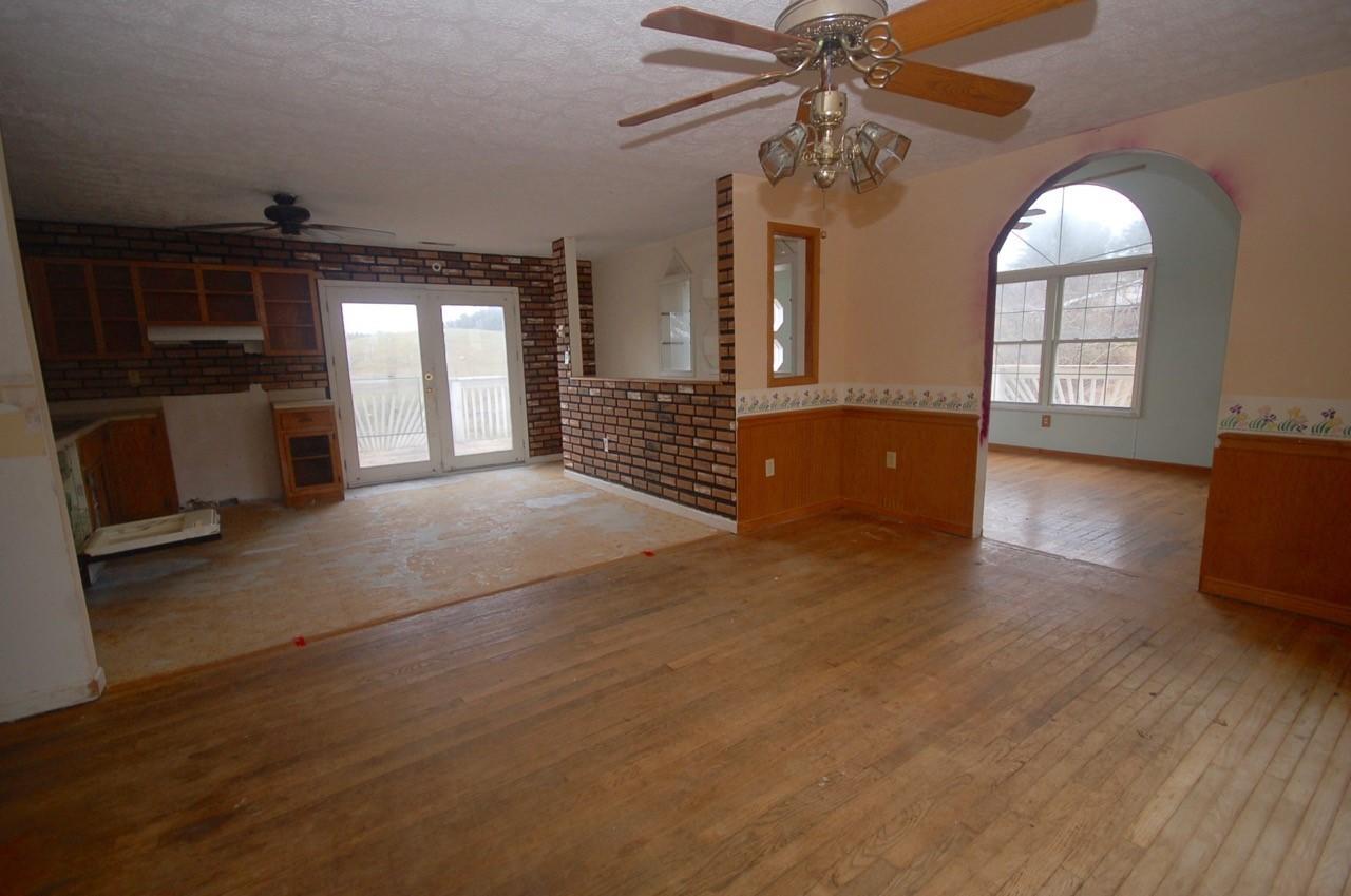 4488 Old Pike Road Pilot, VA 24138 - Photo 11 of 19 a view of empty room with wooden floor and fan