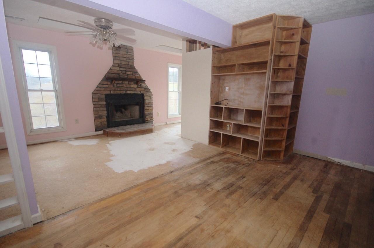 4488 Old Pike Road Pilot, VA 24138 - Photo 13 of 19 an empty room with a fireplace and cabinet