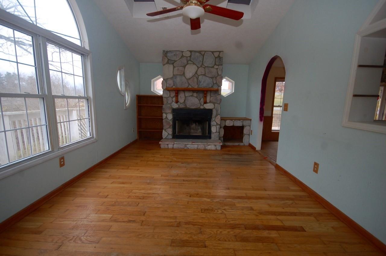 4488 Old Pike Road Pilot, VA 24138 - Photo 8 of 19 wooden floor fireplace and windows in an empty room