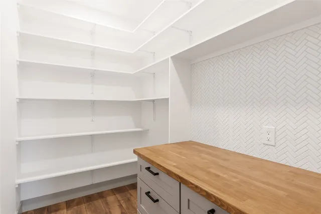 a bathroom with a double vanity sink mirror and bathtub