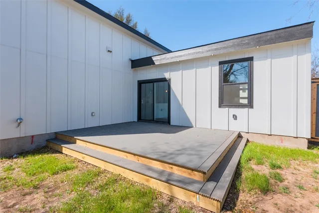 an aerial view of house with yard and mountain view in back