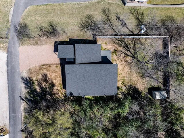 an aerial view of a house with outdoor space