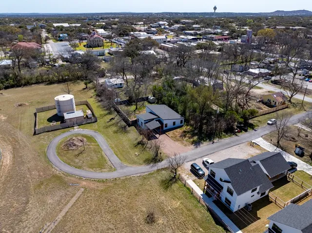 a view of a house with backyard and trees