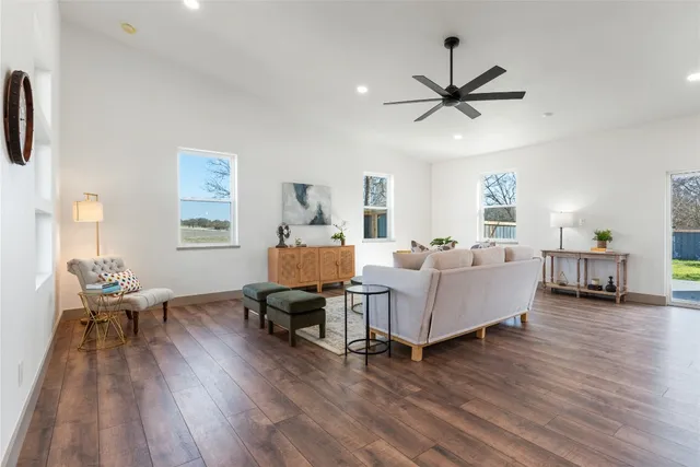 a living room with furniture and a wooden floor