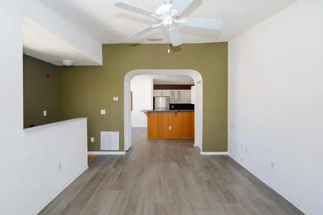 a kitchen with granite countertop white cabinets and black appliances