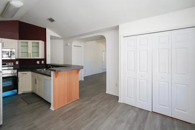 a kitchen with stainless steel appliances a refrigerator sink and microwave