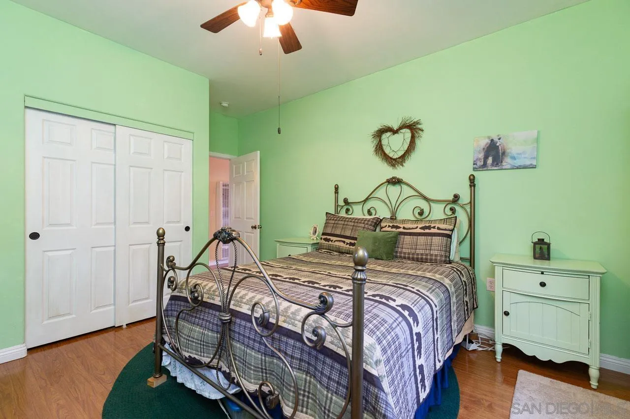 8048 High Hill Road Julian, CA 92036 - Photo 14 of 30 a bedroom with a bed and chandelier