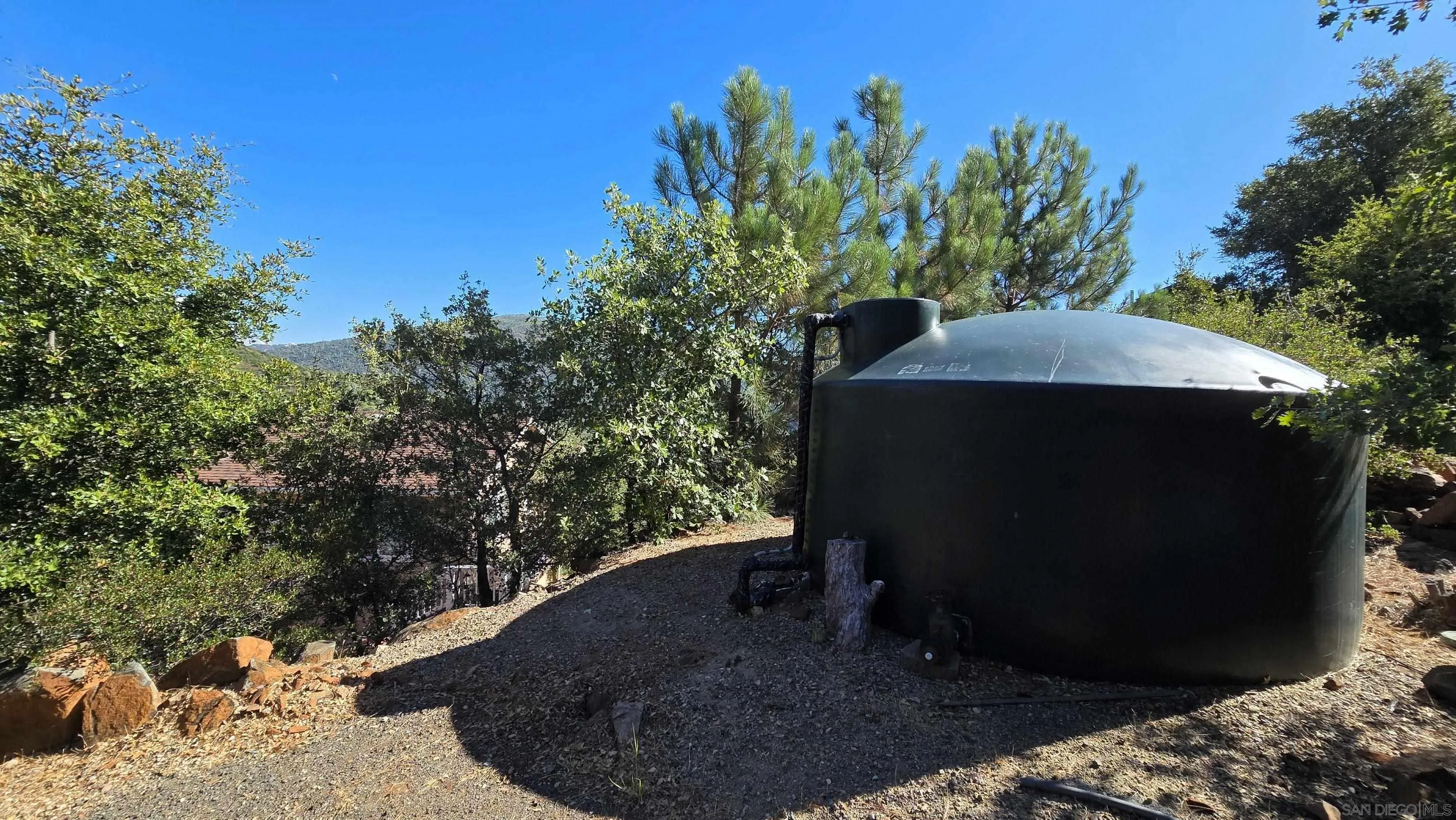 8048 High Hill Road Julian, CA 92036 - Photo 25 of 30 a view of a backyard with plants and a tree