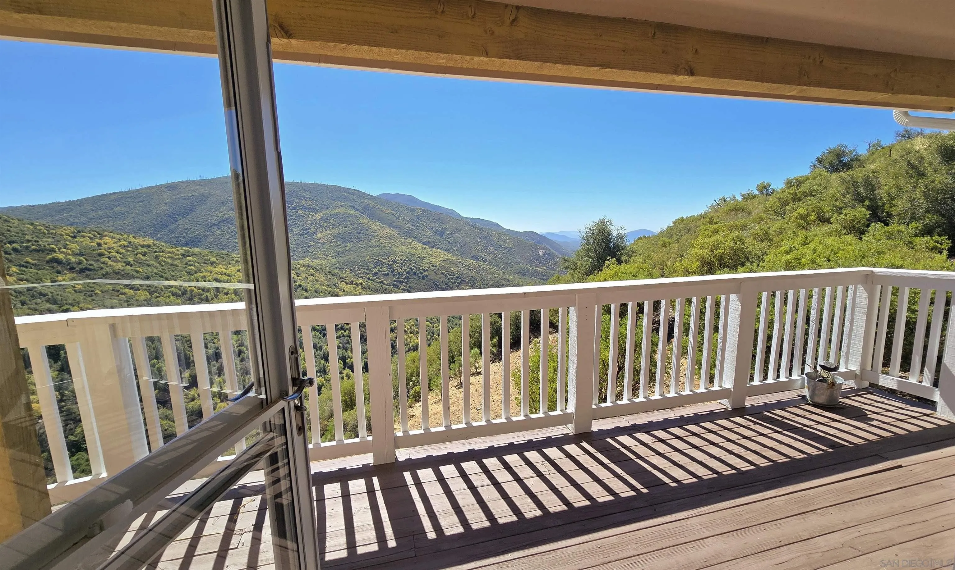 8048 High Hill Road Julian, CA 92036 - Photo 9 of 30 a view of a balcony with wooden floor next to a mountain