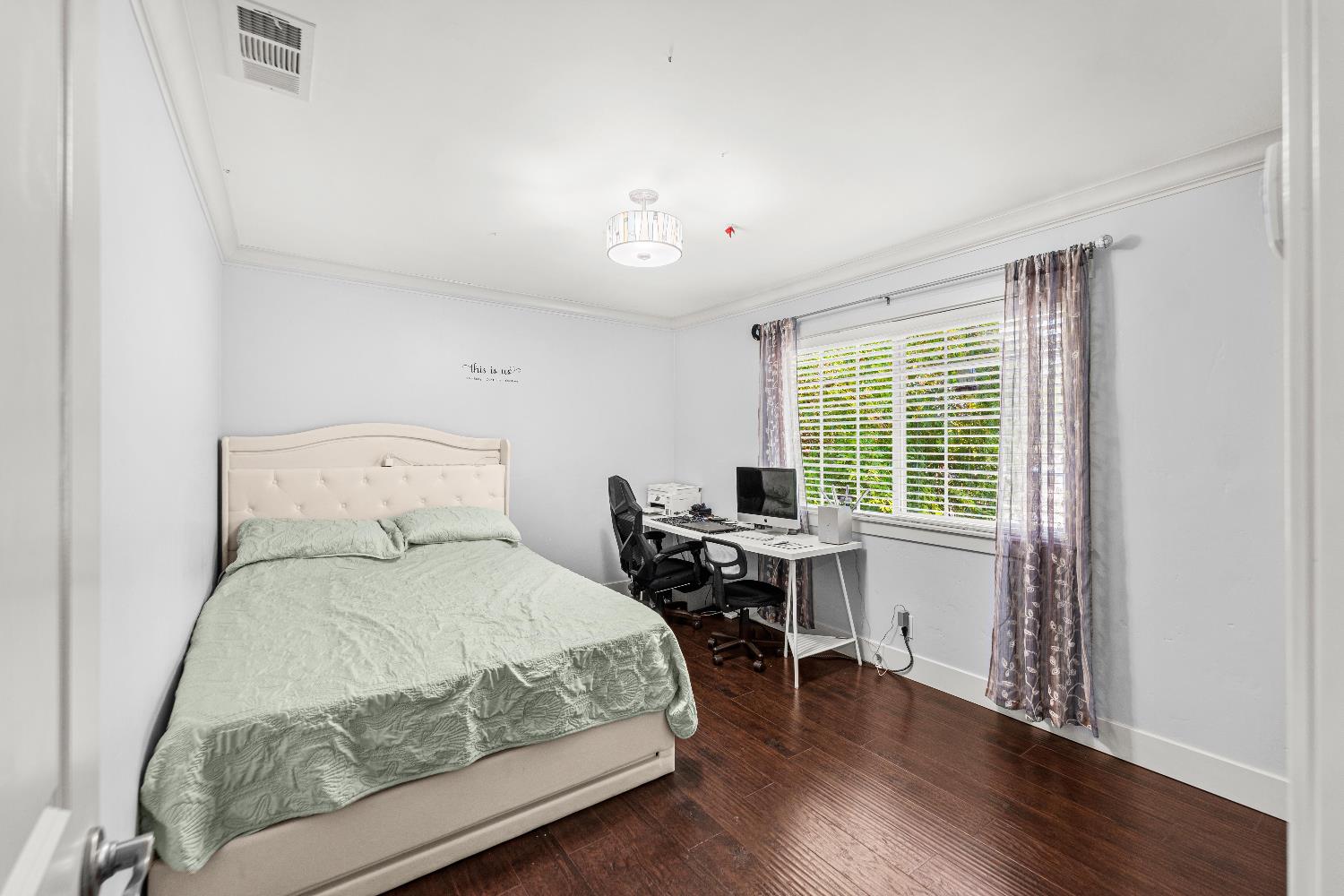 10835 Coloma Road, Unit 3 Rancho Cordova, CA 95670 - Photo 22 of 31 a bedroom with a bed and a desk