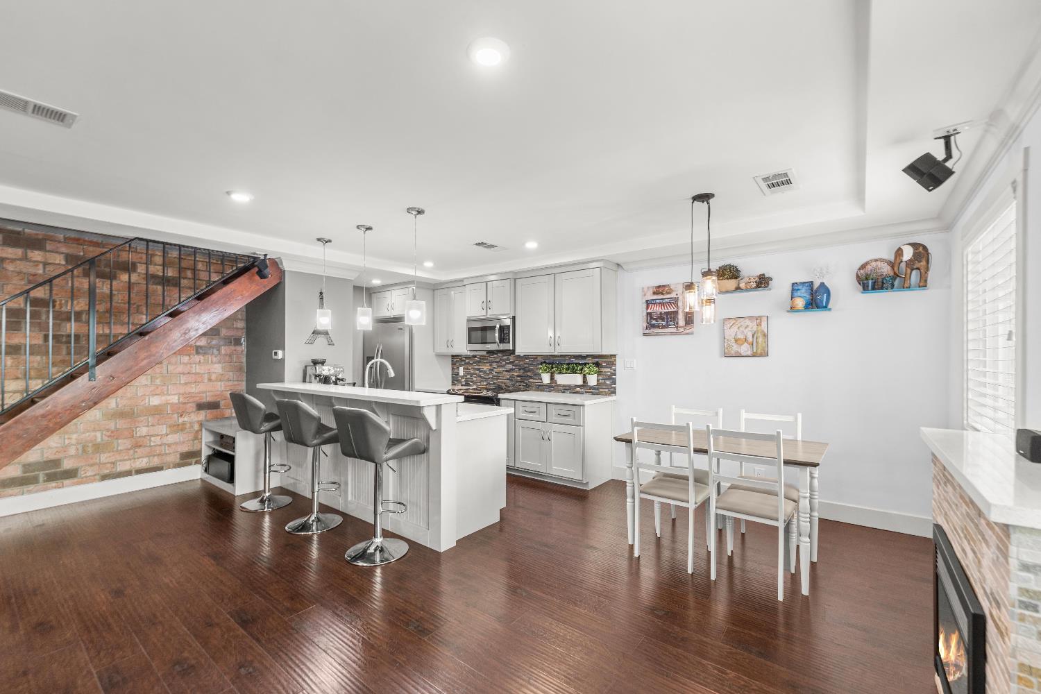 10835 Coloma Road, Unit 3 Rancho Cordova, CA 95670 - Photo 6 of 31 a kitchen with white cabinets and chairs