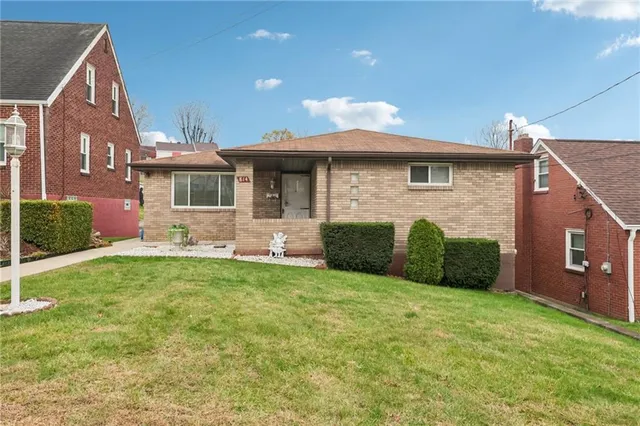 a front view of a house with yard