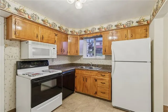 a kitchen with a refrigerator and a stove top oven