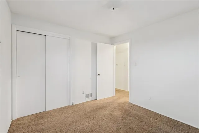 an empty room with wooden floor