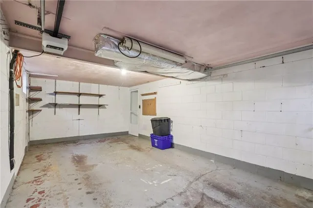 a front view of a house with a garden and garage