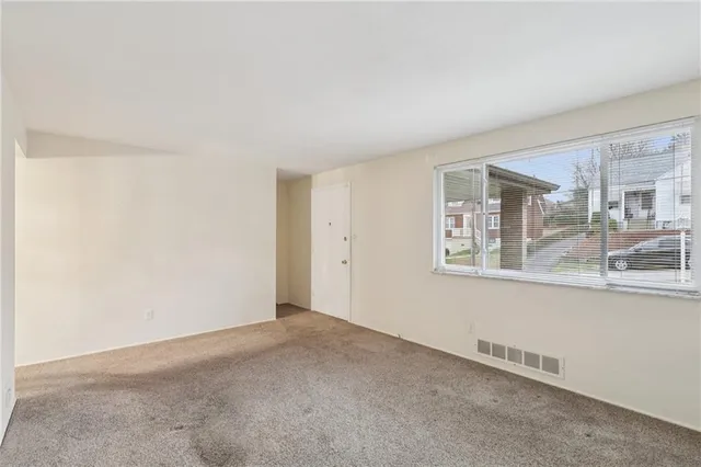 a view of an empty room with a window