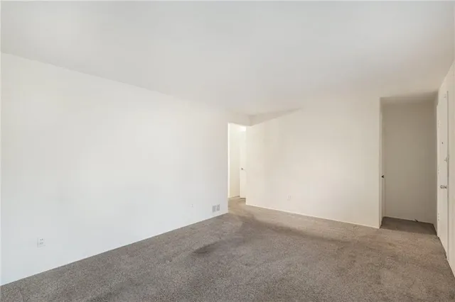 a view of a dining room with furniture a chandelier and wooden floor