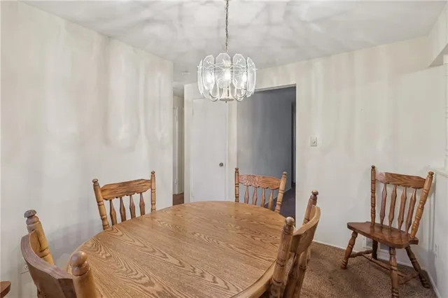 a view of a dining room with furniture and a chandelier