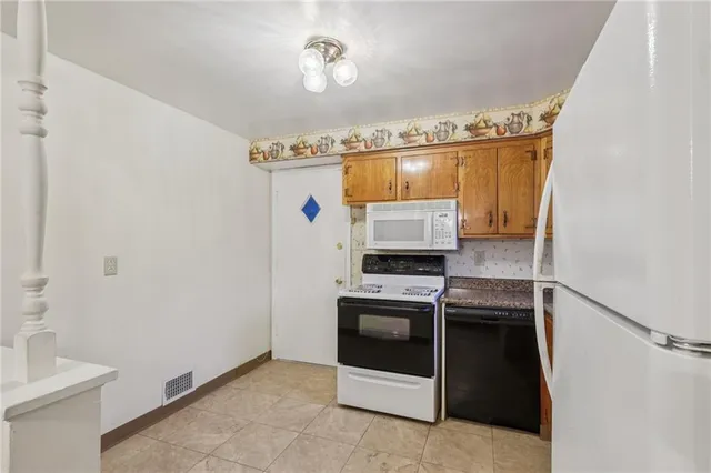 a kitchen with a stove a sink and a refrigerator