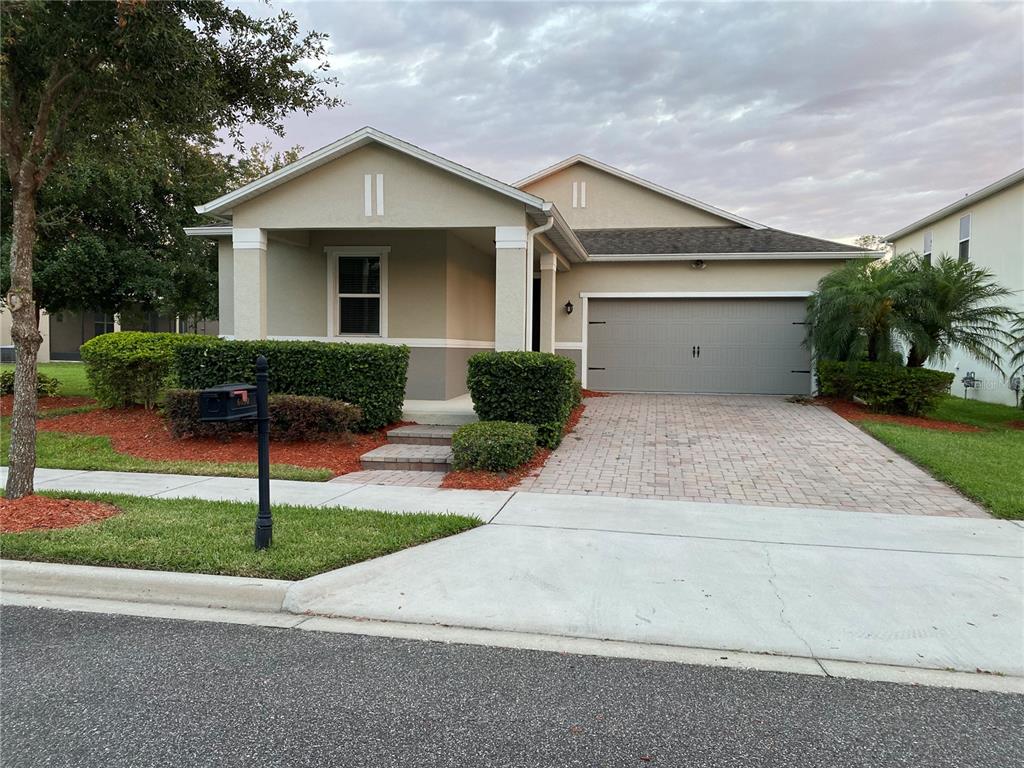 6650 Merrick Landing Boulevard Windermere, FL 34786 - Photo 1 of 1 a front view of a house with a yard and garage