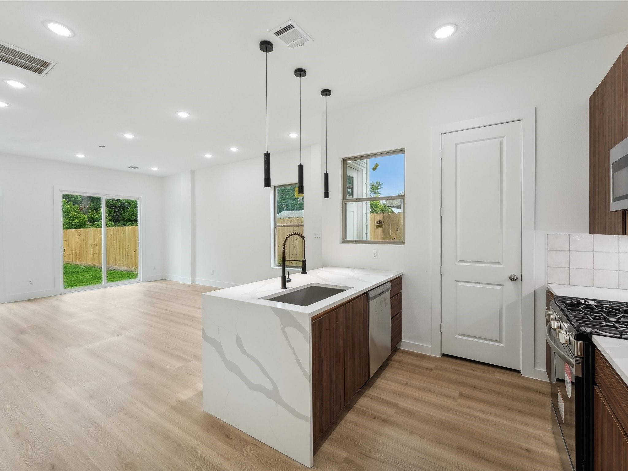 7416 Maxroy Street Houston, TX 77088 - Photo 11 of 41 a kitchen with stainless steel appliances granite countertop a sink and a stove top oven