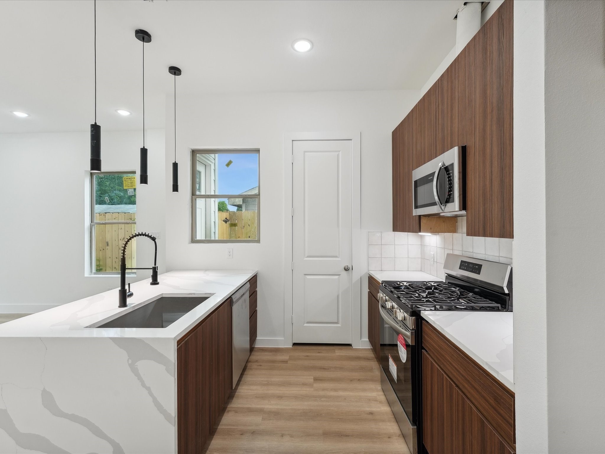 7416 Maxroy Street Houston, TX 77088 - Photo 12 of 41 a kitchen that has a sink and a stove top oven