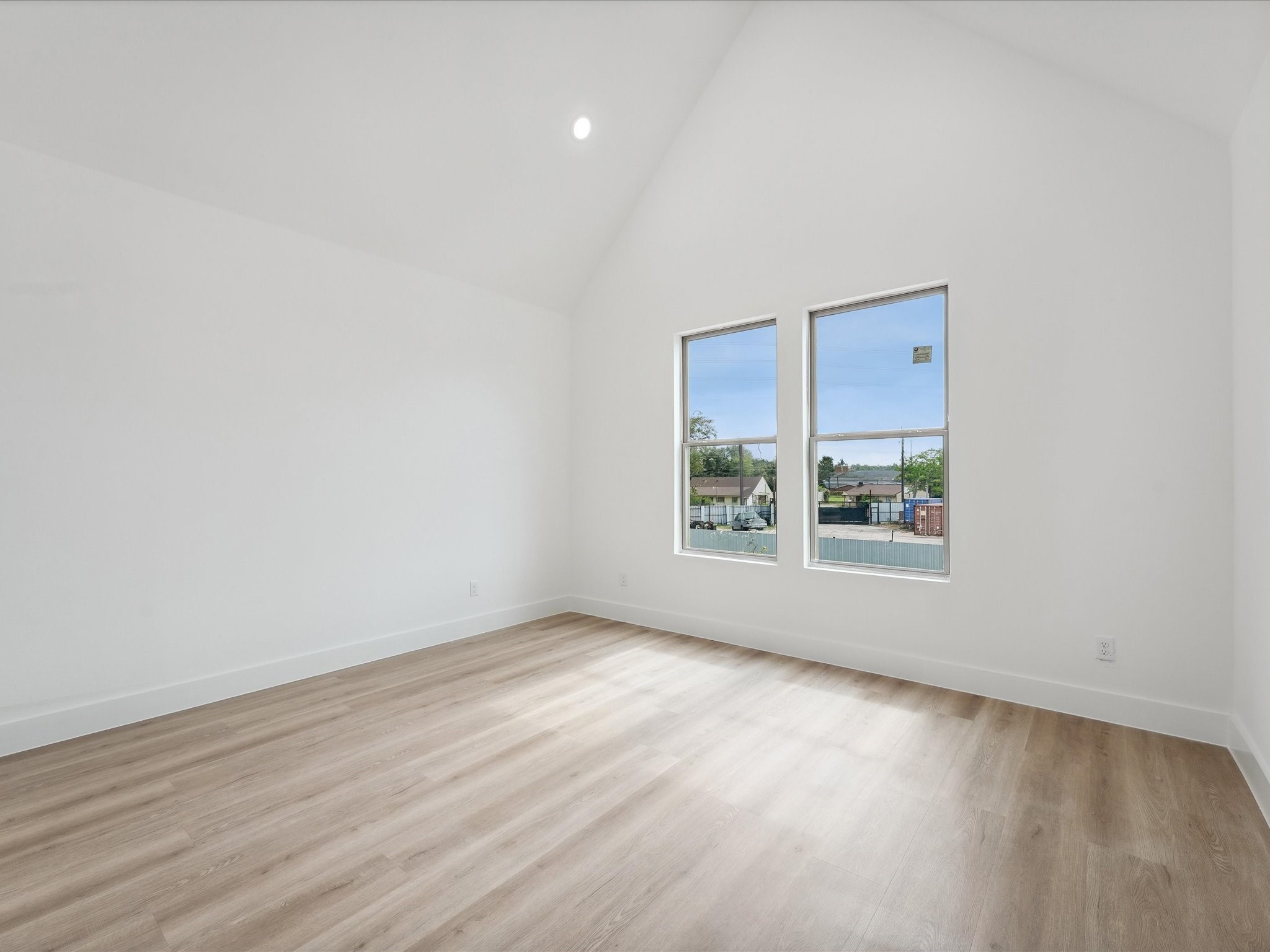 7416 Maxroy Street Houston, TX 77088 - Photo 15 of 41 a view of an empty room with wooden floor and a window