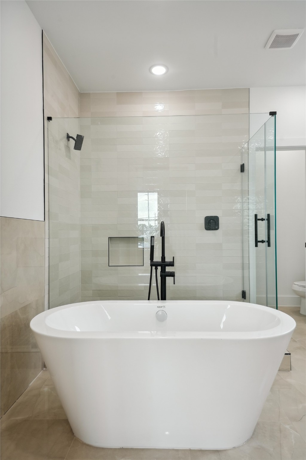 7416 Maxroy Street Houston, TX 77088 - Photo 21 of 41 a bathroom with a bathtub and shower