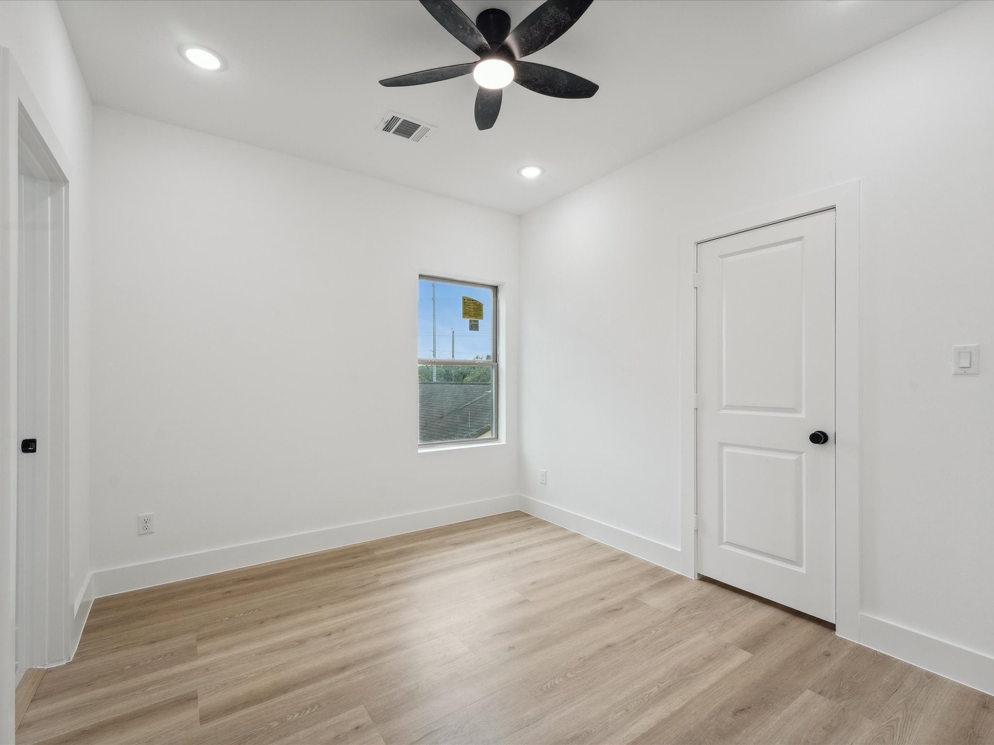 7416 Maxroy Street Houston, TX 77088 - Photo 26 of 41 wooden floor in an empty room with a window