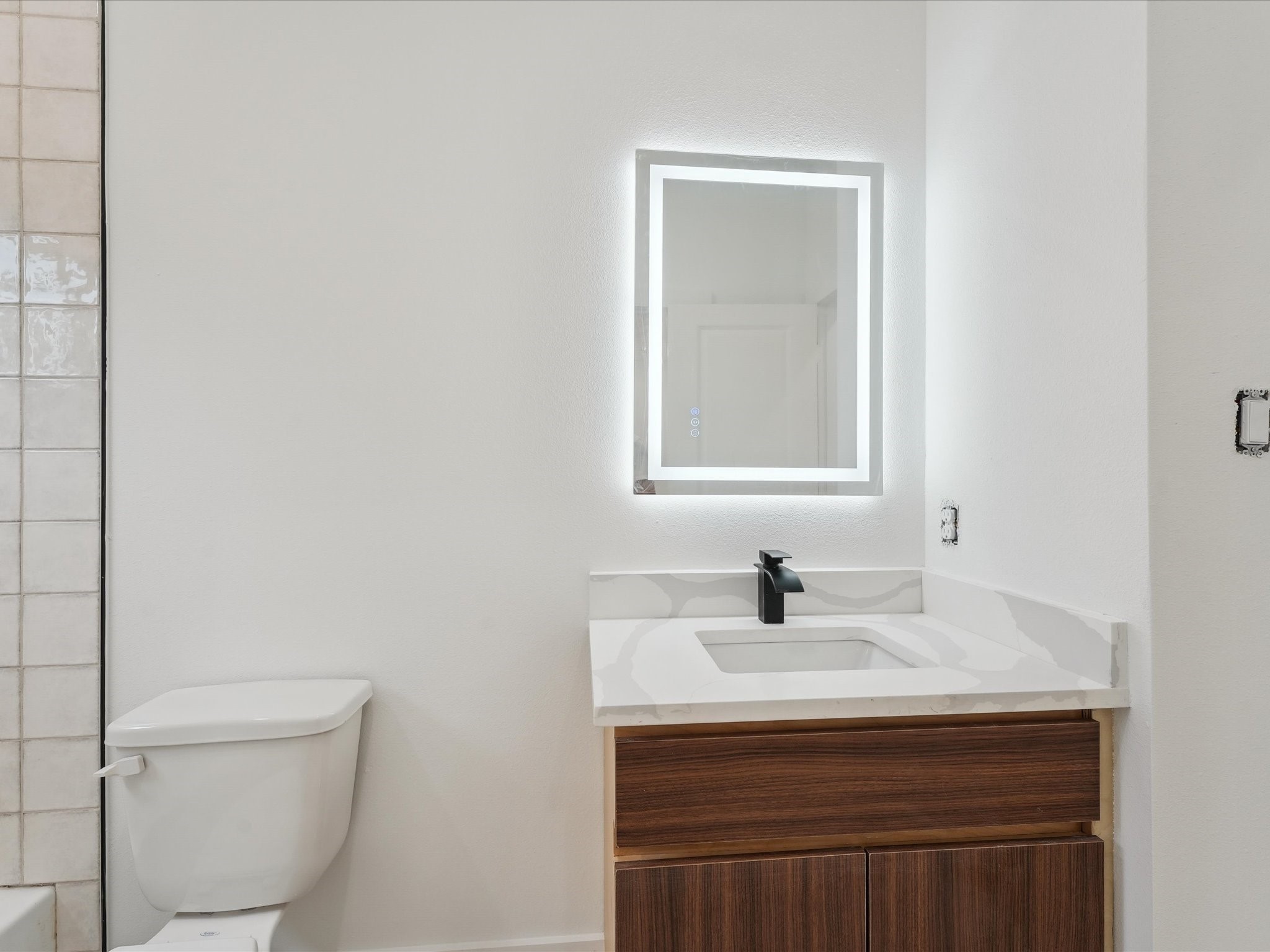 7416 Maxroy Street Houston, TX 77088 - Photo 31 of 41 a bathroom with a toilet sink and mirror