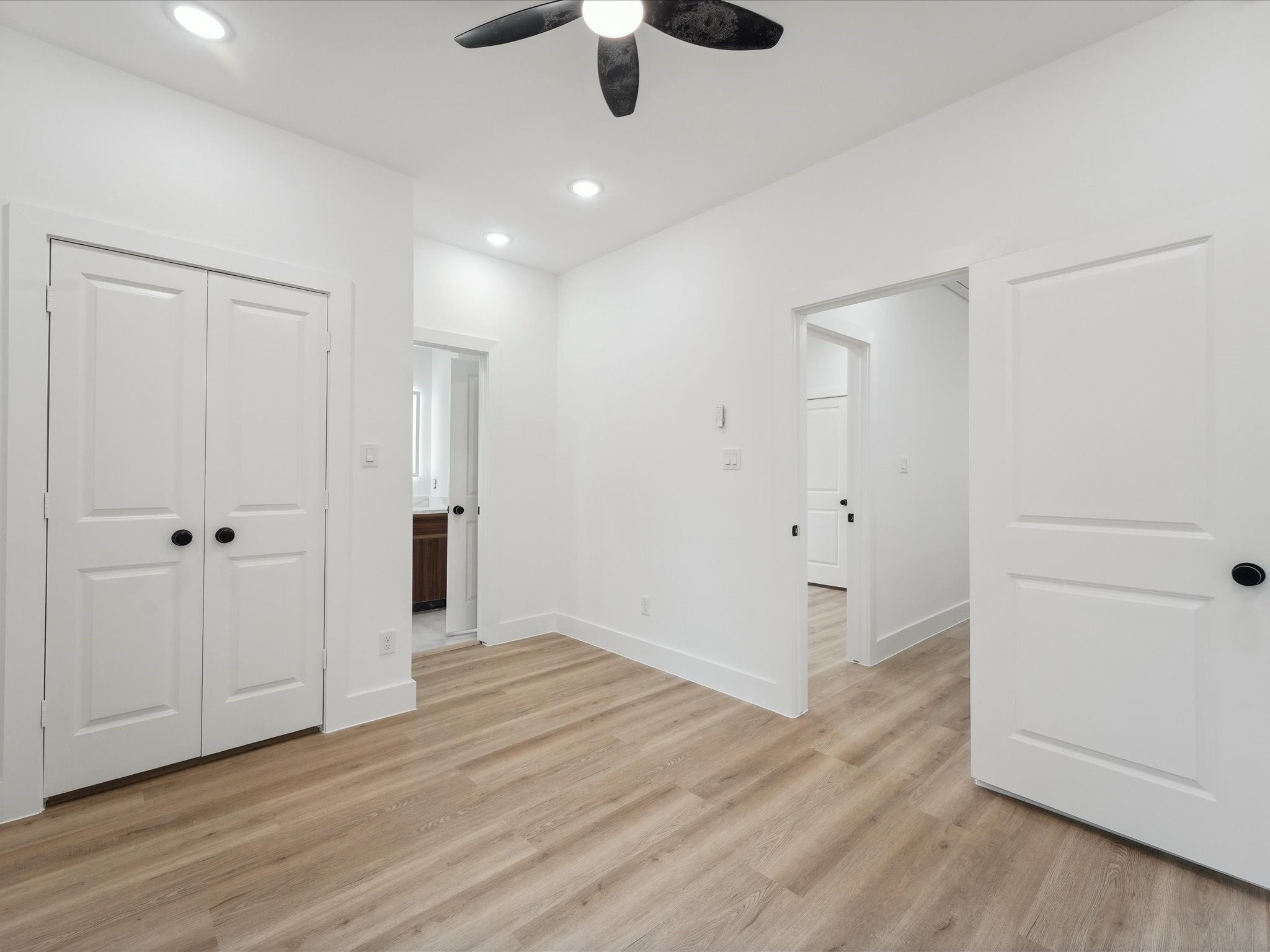 7416 Maxroy Street Houston, TX 77088 - Photo 34 of 41 an empty room with wooden floor cabinet and a ceiling fan