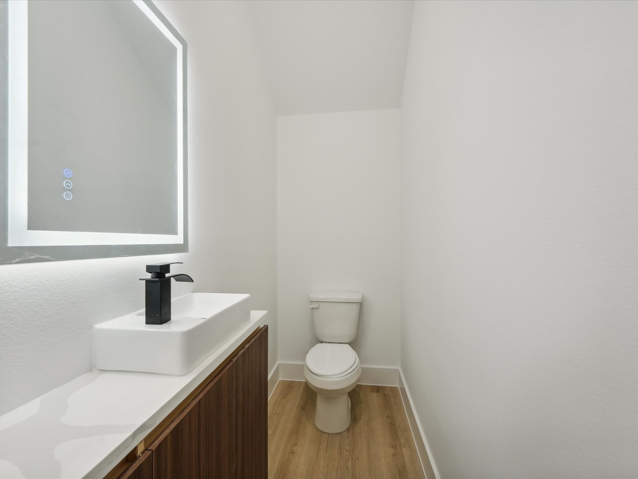 7416 Maxroy Street Houston, TX 77088 - Photo 35 of 41 a bathroom with a toilet a sink and mirror