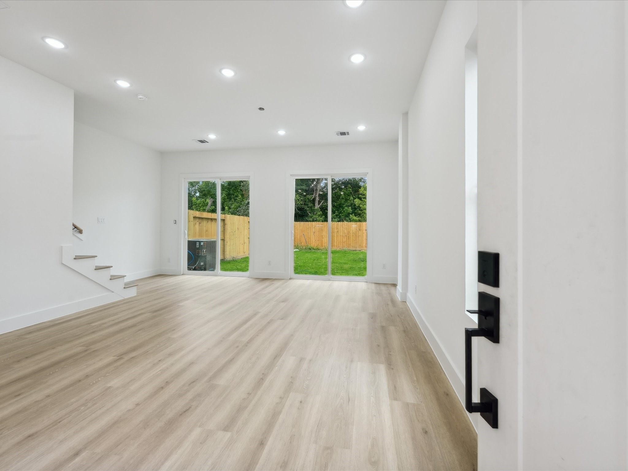 7416 Maxroy Street Houston, TX 77088 - Photo 6 of 41 an empty room with a window and wooden floor