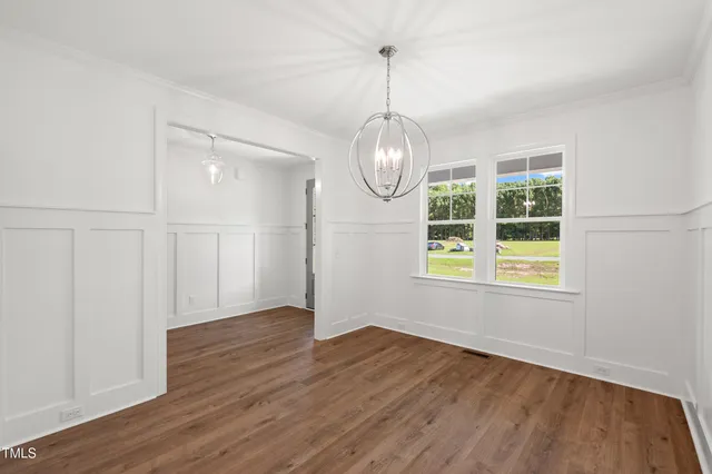 a view of a livingroom with wooden floor and fireplace