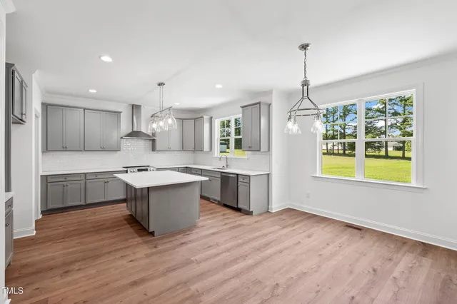 a kitchen with a sink stove and refrigerator