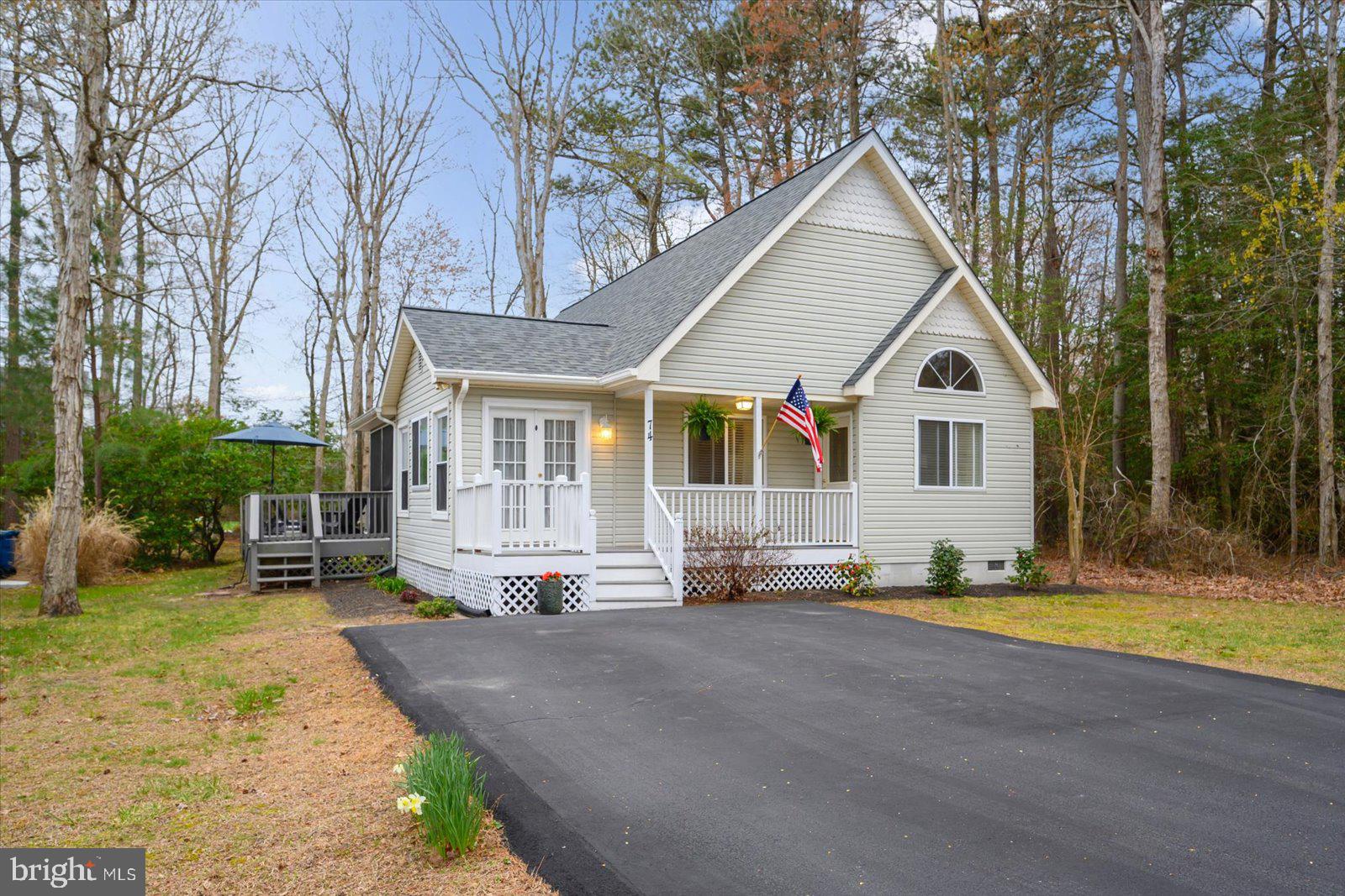 74 Robin Hood Trail Ocean Pines, MD 21811 - Photo 1 of 59 a view of a white house with a big yard and large trees