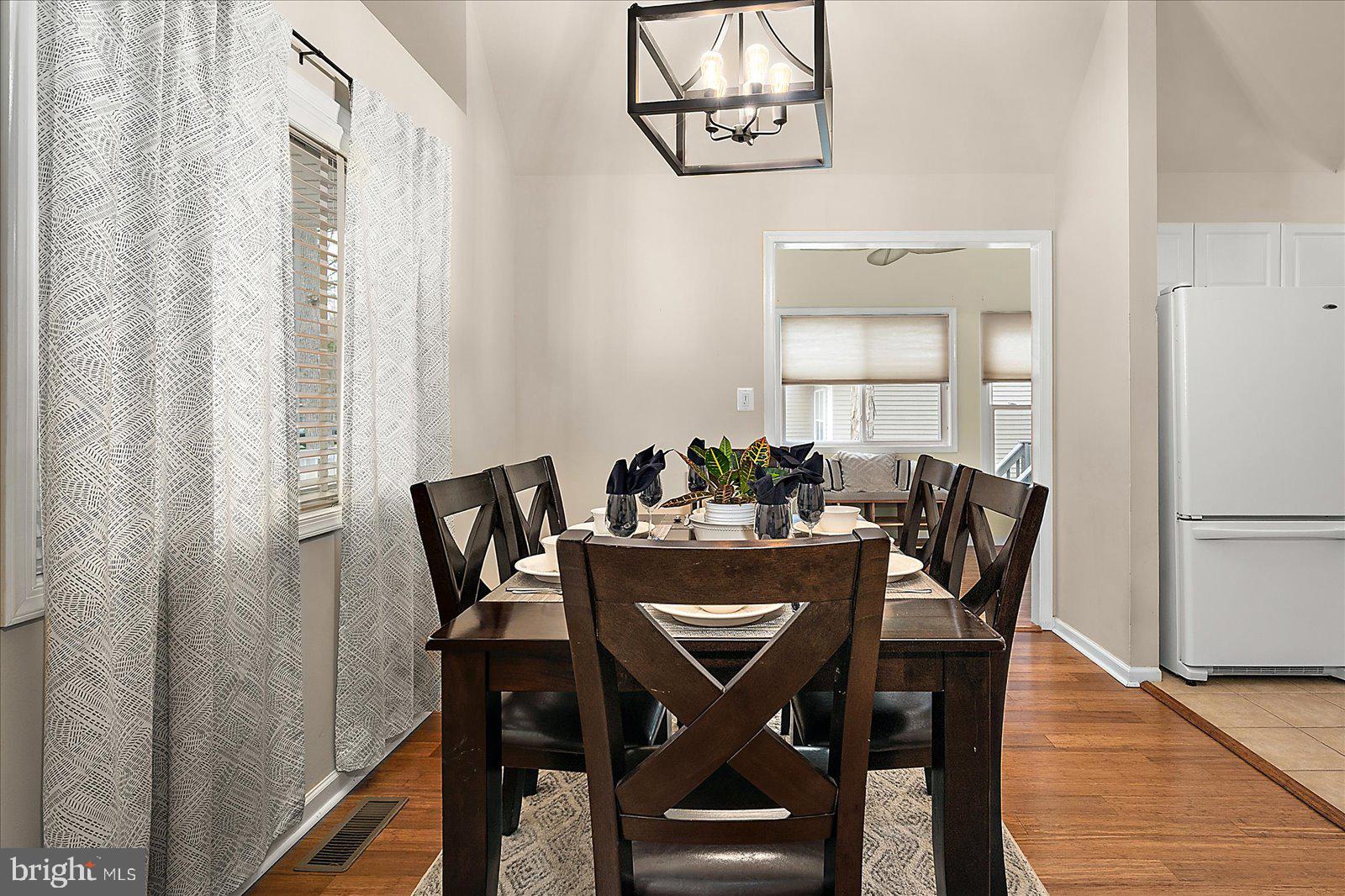 74 Robin Hood Trail Ocean Pines, MD 21811 - Photo 14 of 59 a view of a dining room with furniture and wooden floor