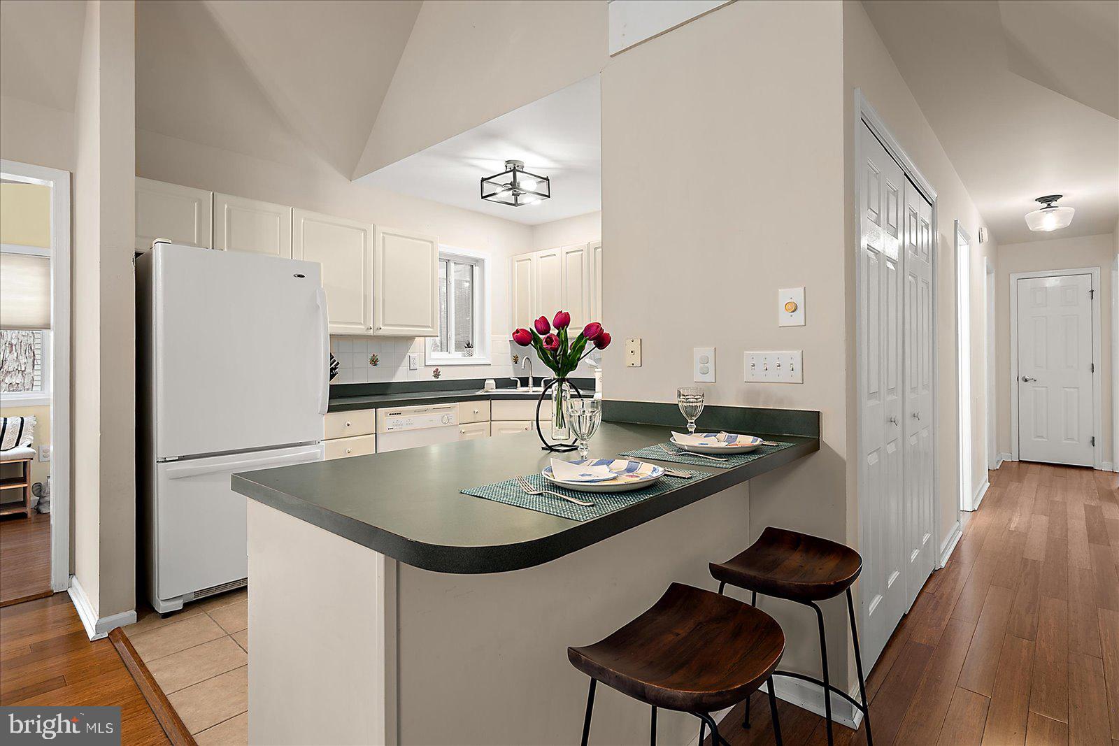 74 Robin Hood Trail Ocean Pines, MD 21811 - Photo 15 of 59 a kitchen with stainless steel appliances a dining table chairs and refrigerator