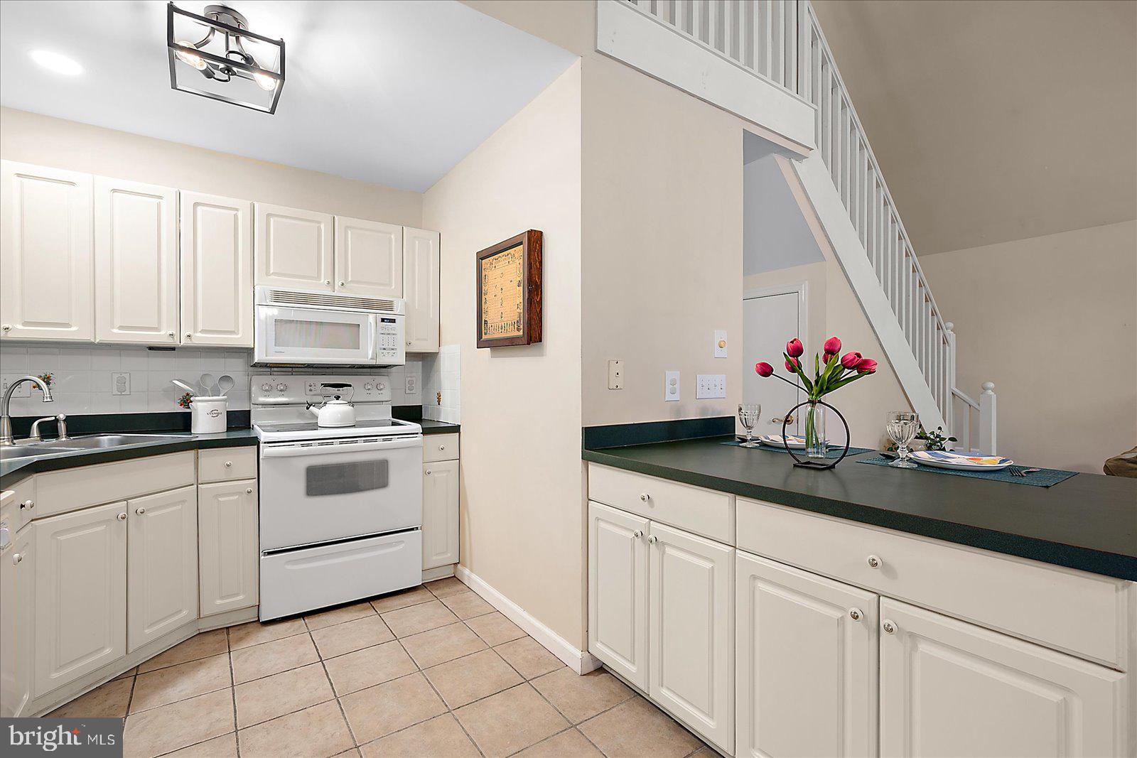 74 Robin Hood Trail Ocean Pines, MD 21811 - Photo 19 of 59 a kitchen with white cabinets and white appliances