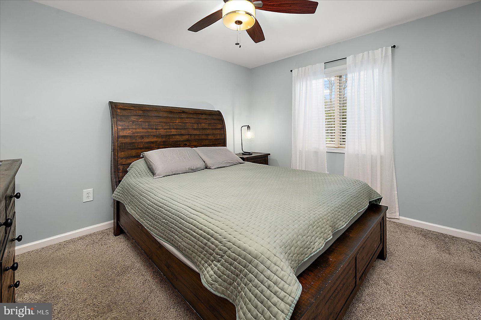 74 Robin Hood Trail Ocean Pines, MD 21811 - Photo 20 of 59 a spacious bedroom with a bed and window